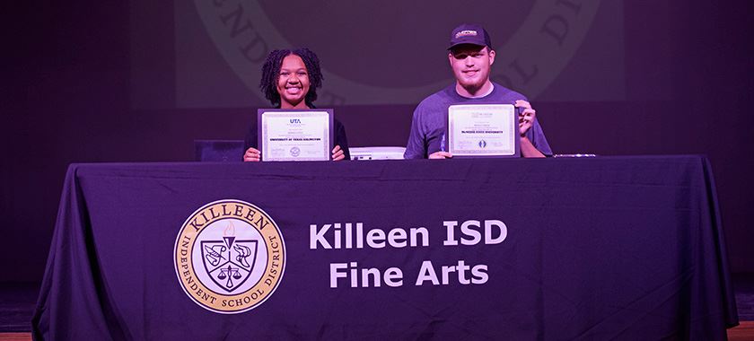 Brianni Gaines and Bradley Gibson sign fine arts letters