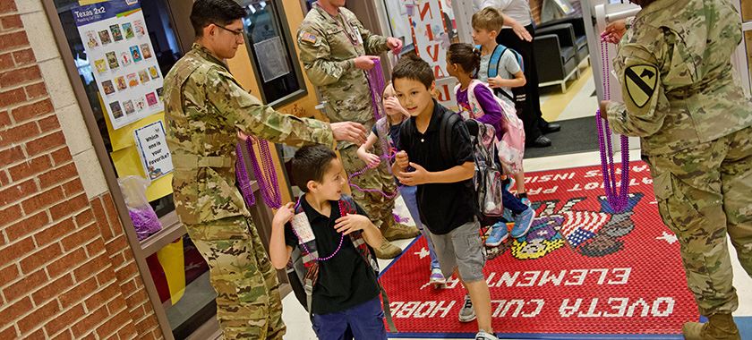  Soldiers distribute purple beads honoring military children