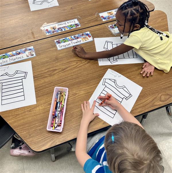 Student working on patterns by coloring a striped shirt