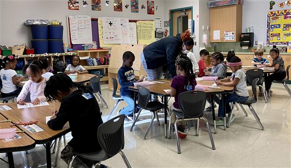 Students working on patterns by coloring a striped shirt